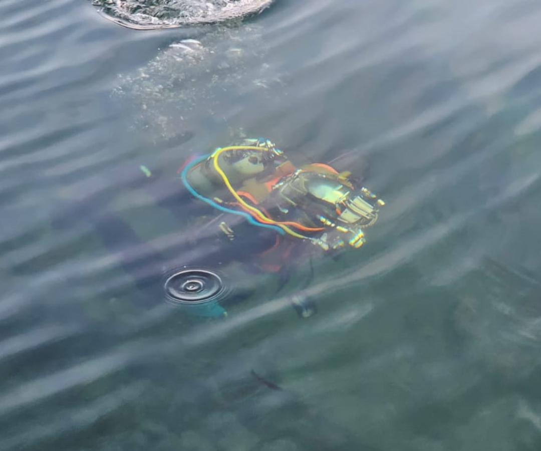HDD exit support 3 A commercial diver wearing a helmet in shallow water.